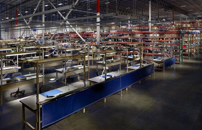 image inside a logistics warehouse looking at work stations
