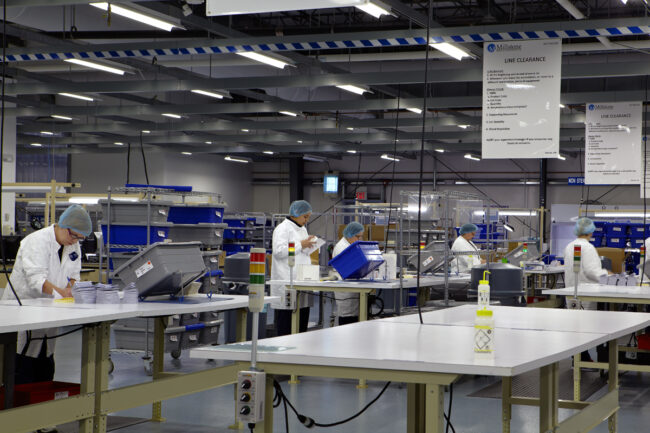 image of five people working on packaging in logistics