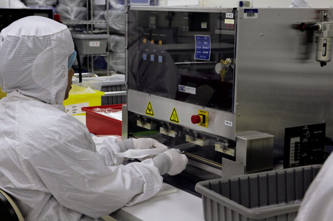 image of a person using a machine in a cleanroom
