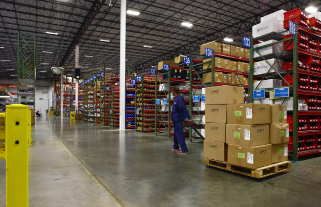 image of a man pulling a pallet of packages in logistics 4
