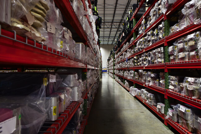 image of an aisle of organized inventory in a logistics warehouse