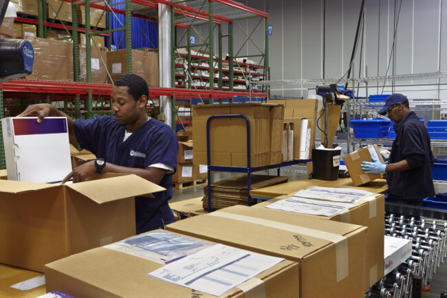 image of two men handling boxes in logistics