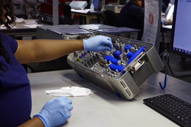 image of person placing a medical device into a container