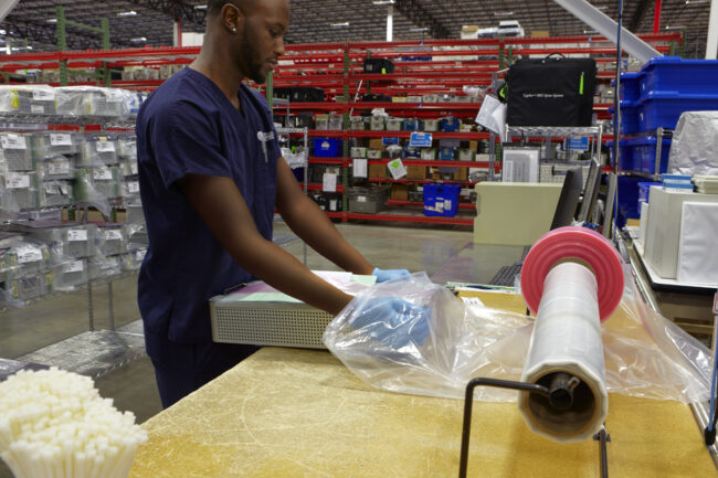 image of a person packaging a loaner kit