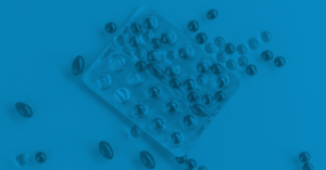 half opened package of supplement pills spread across the table 