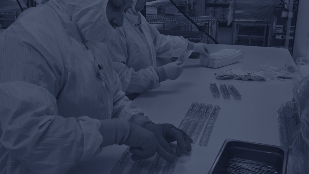 Millstone cleanroom team assembling robotic medical device packaging for sterile validation.